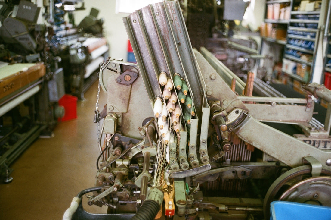 Close-up of a complex industrial machine with spools.