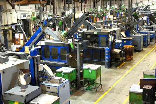 Industrial factory floor with machinery and yellow lines.
