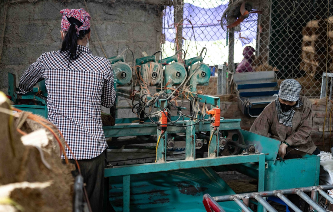 Workers operating machinery in a factory setting.