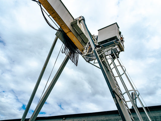 A large industrial crane against a cloudy sky